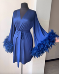 a blue dress with feathers on a mannequin