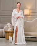 Side view of long bridal robe with lace train and wide sleeves, soft satin texture and floral details