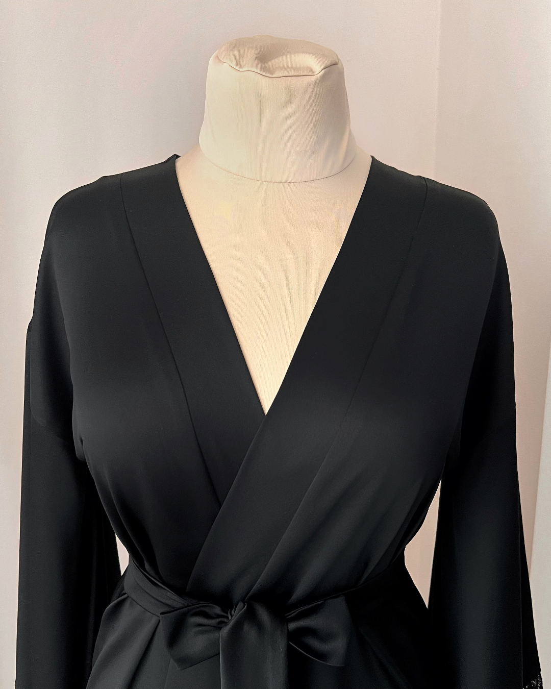 a woman's black dress on a mannequin
