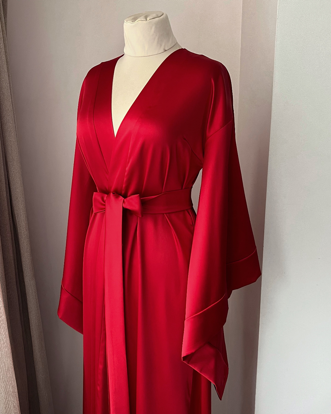 a woman's red robe on a mannequin