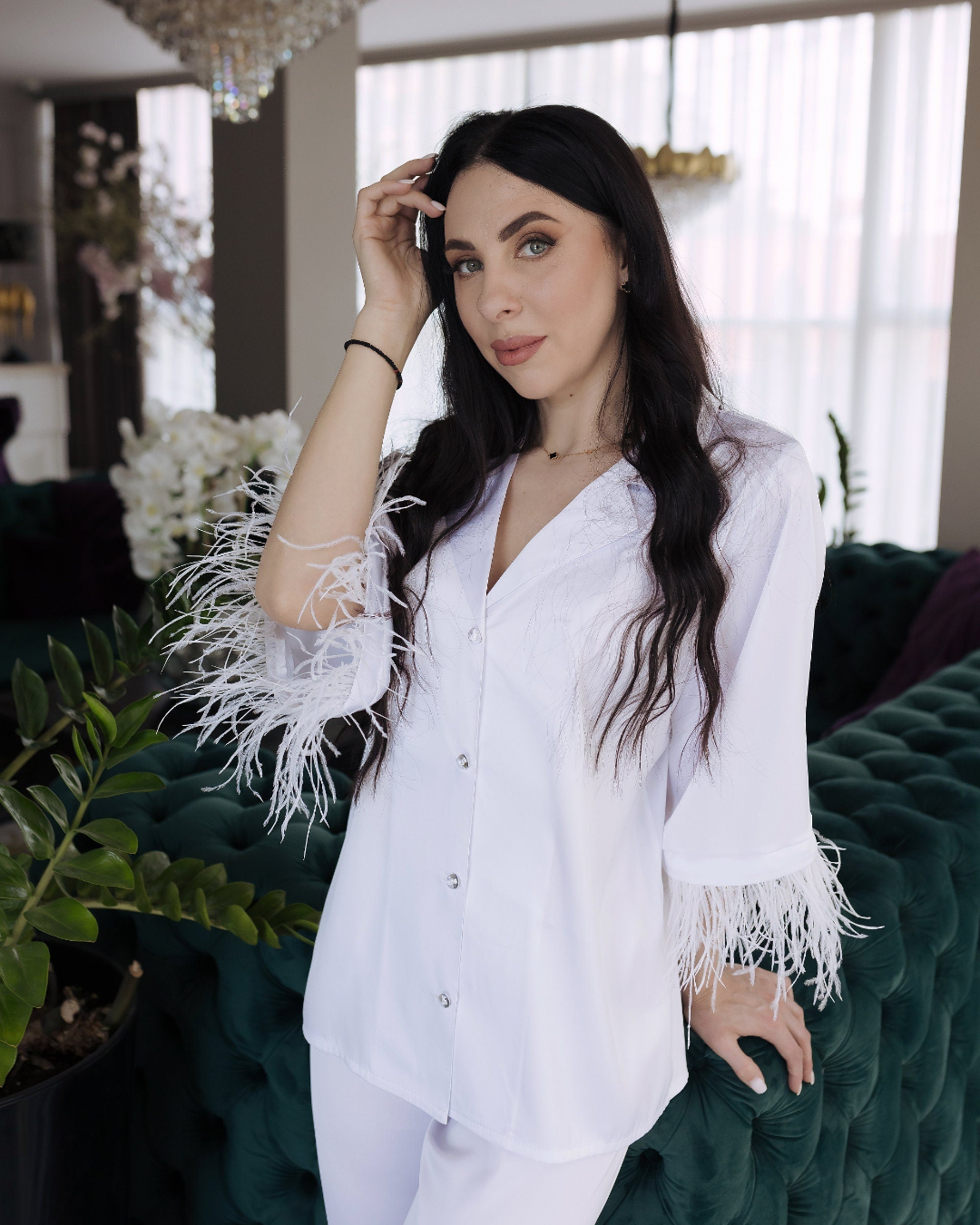 a woman wearing a white shirt and white pants