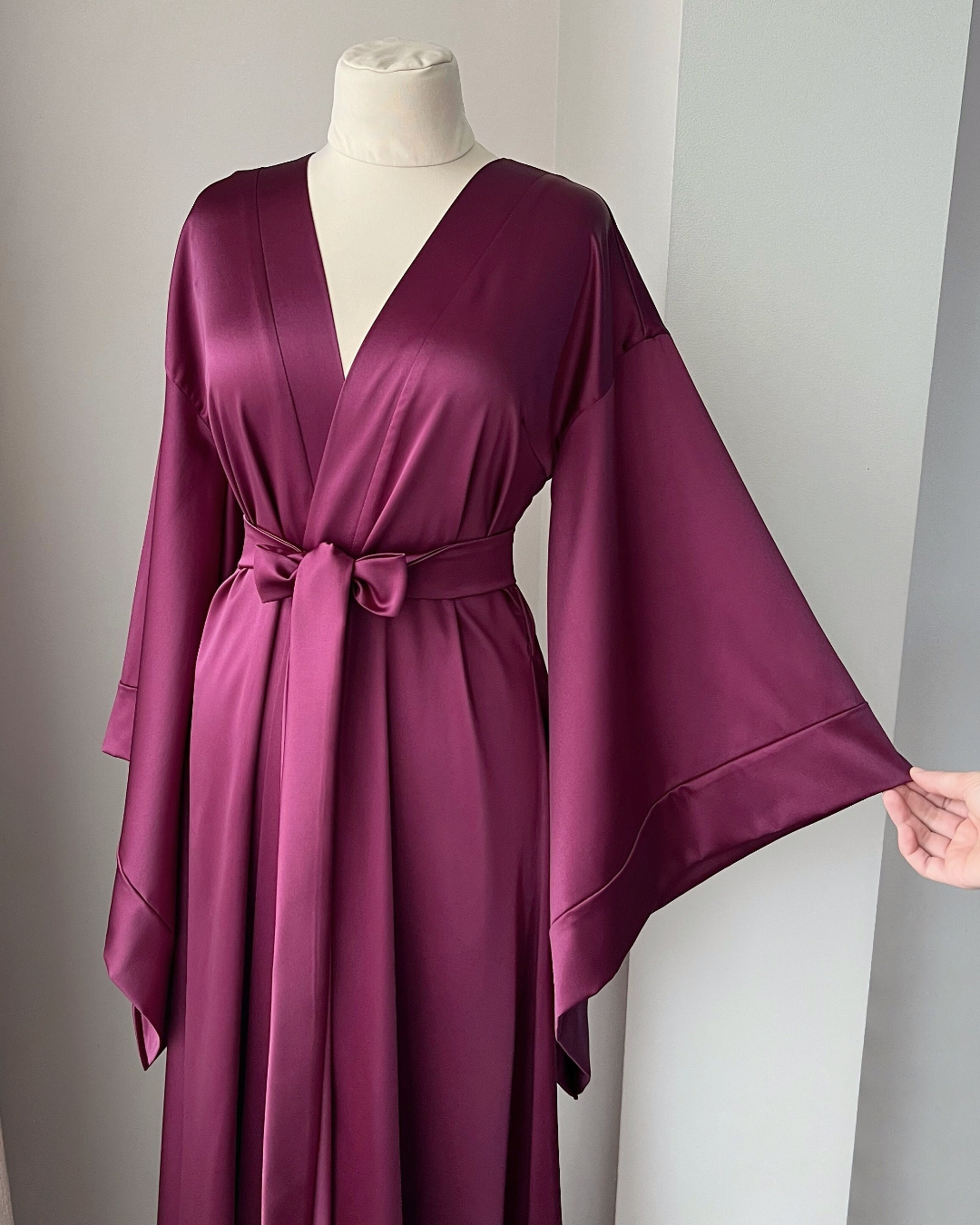 a woman's purple robe on a mannequin