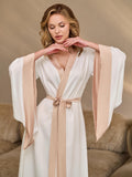 Close-up of ivory silk satin robe with contrast cappuccino trim on the sleeves