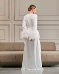 Back view of ivory bridal robe with light ostrich feather cuffs and tie waist, bride with hair in bun