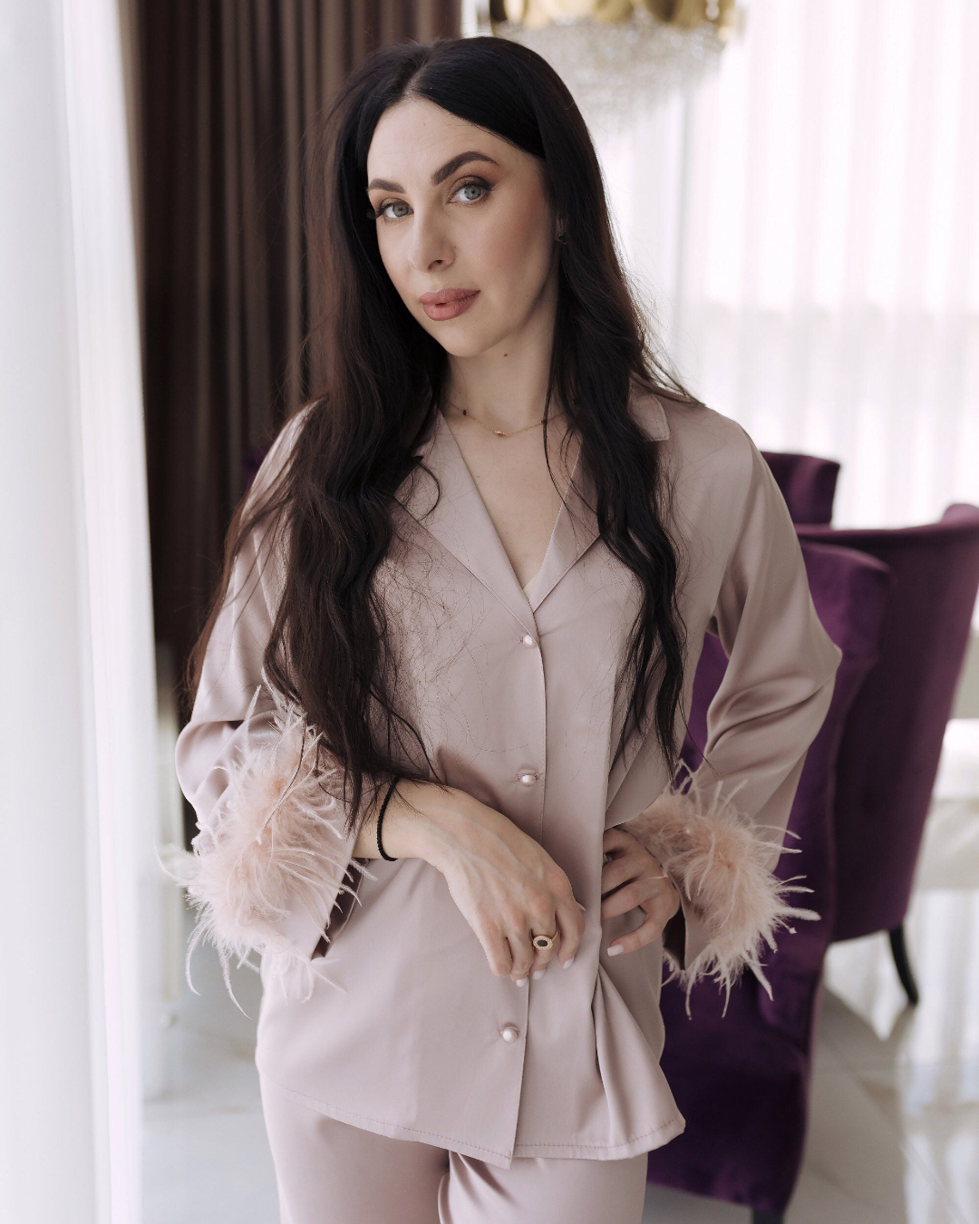 a woman standing in front of a purple chair