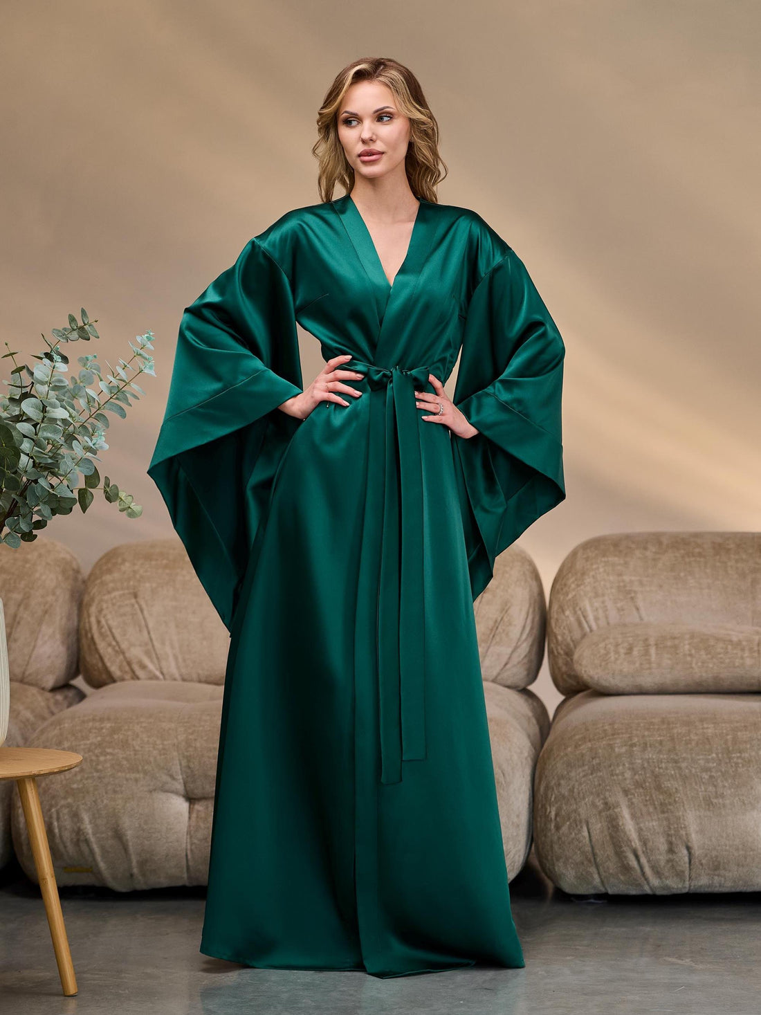 Long emerald satin kimono robe with wide sleeves and waist belt, elegant silhouette.