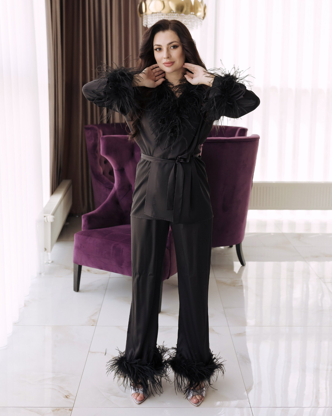 a woman in a black jumpsuit posing for a picture