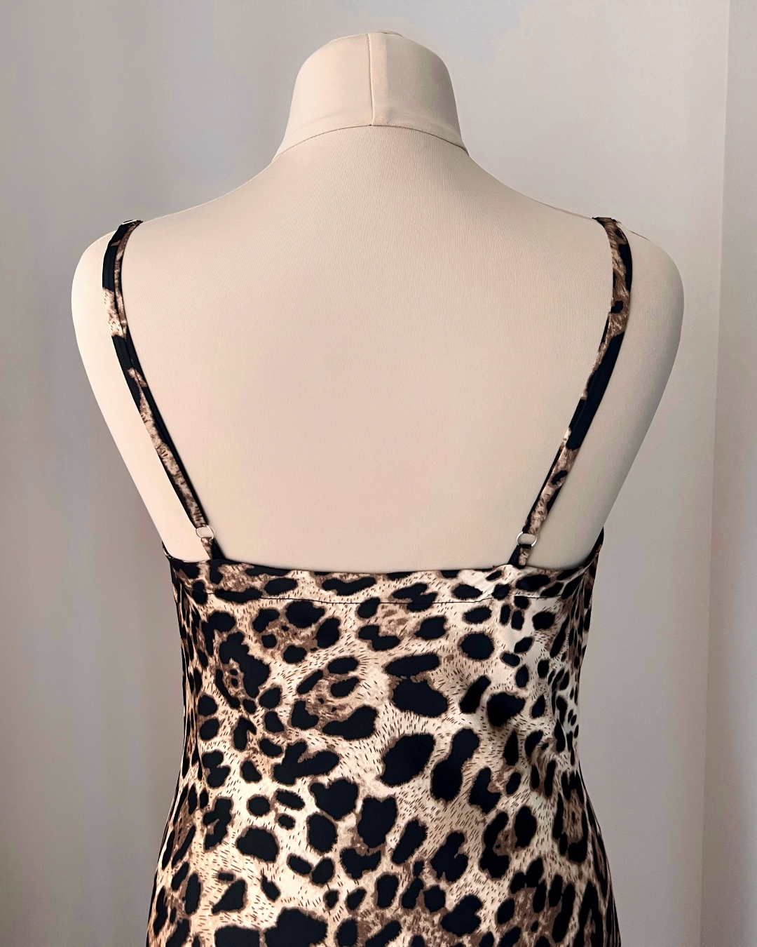 a mannequin wearing a leopard print dress