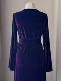 Back waist detail of purple velvet robe with wide belt and smooth plush texture.