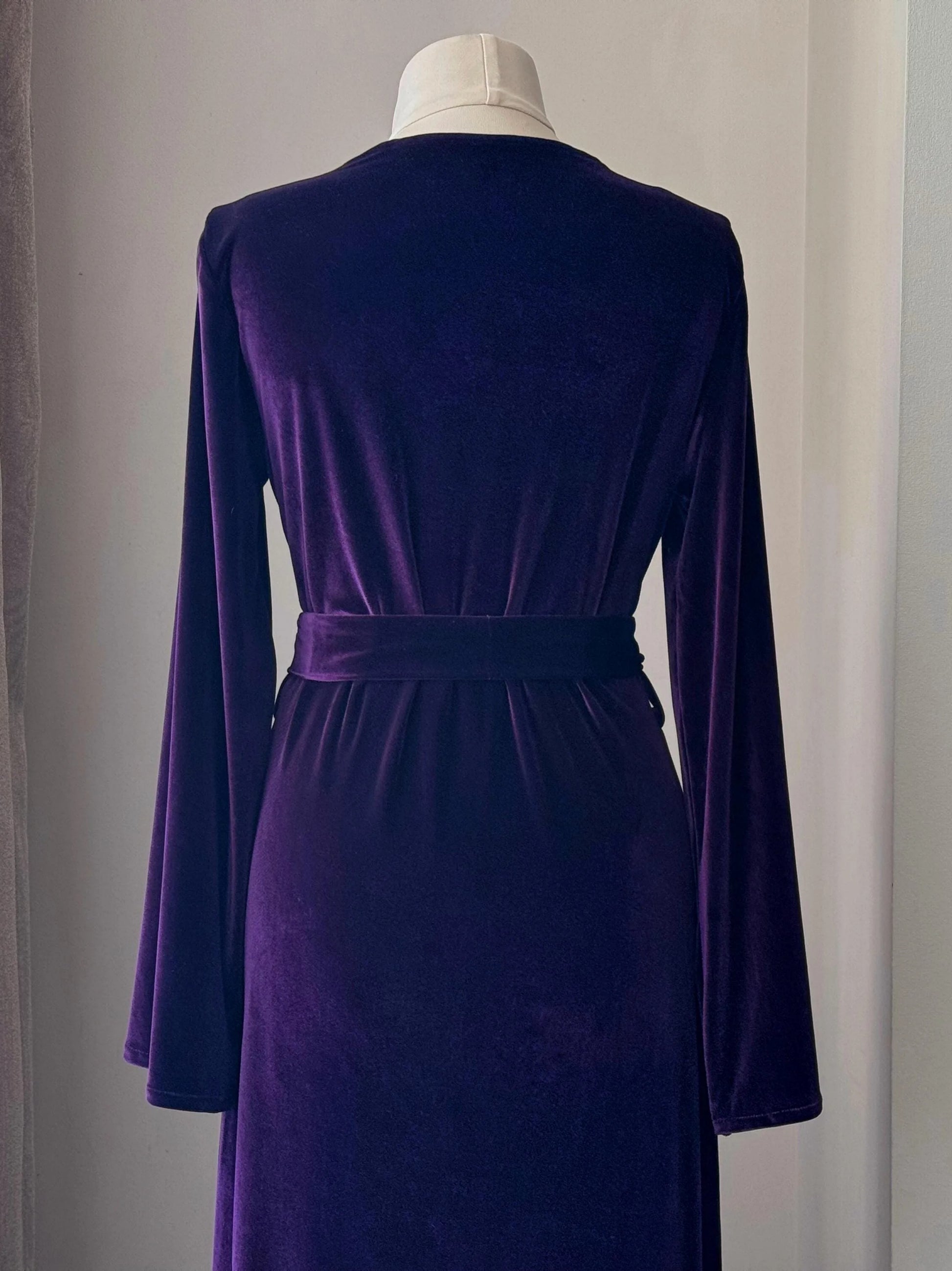 Back waist detail of purple velvet robe with wide belt and smooth plush texture.