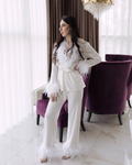 a woman standing in front of a purple chair