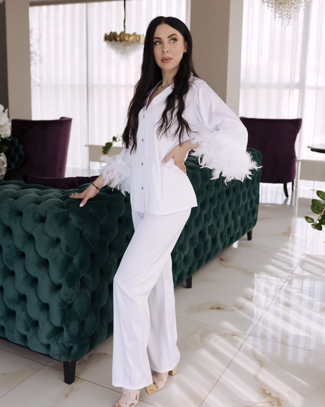 a woman standing in front of a green couch