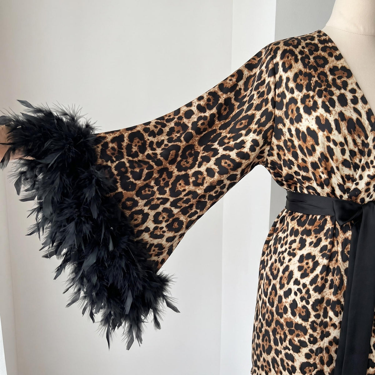 Leopard print feather robe with floor-length shape and soft satin appearance