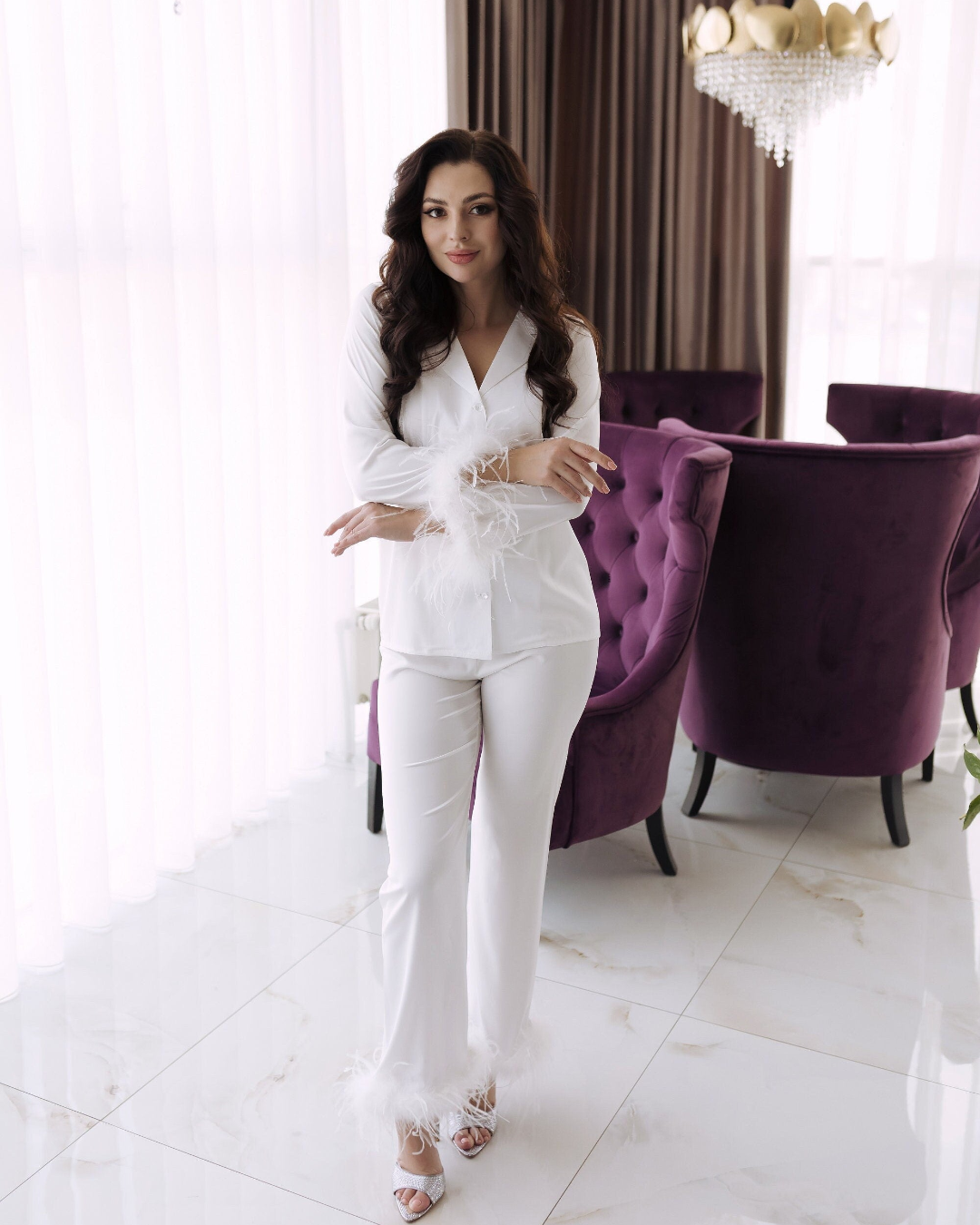 a woman standing in front of a purple chair