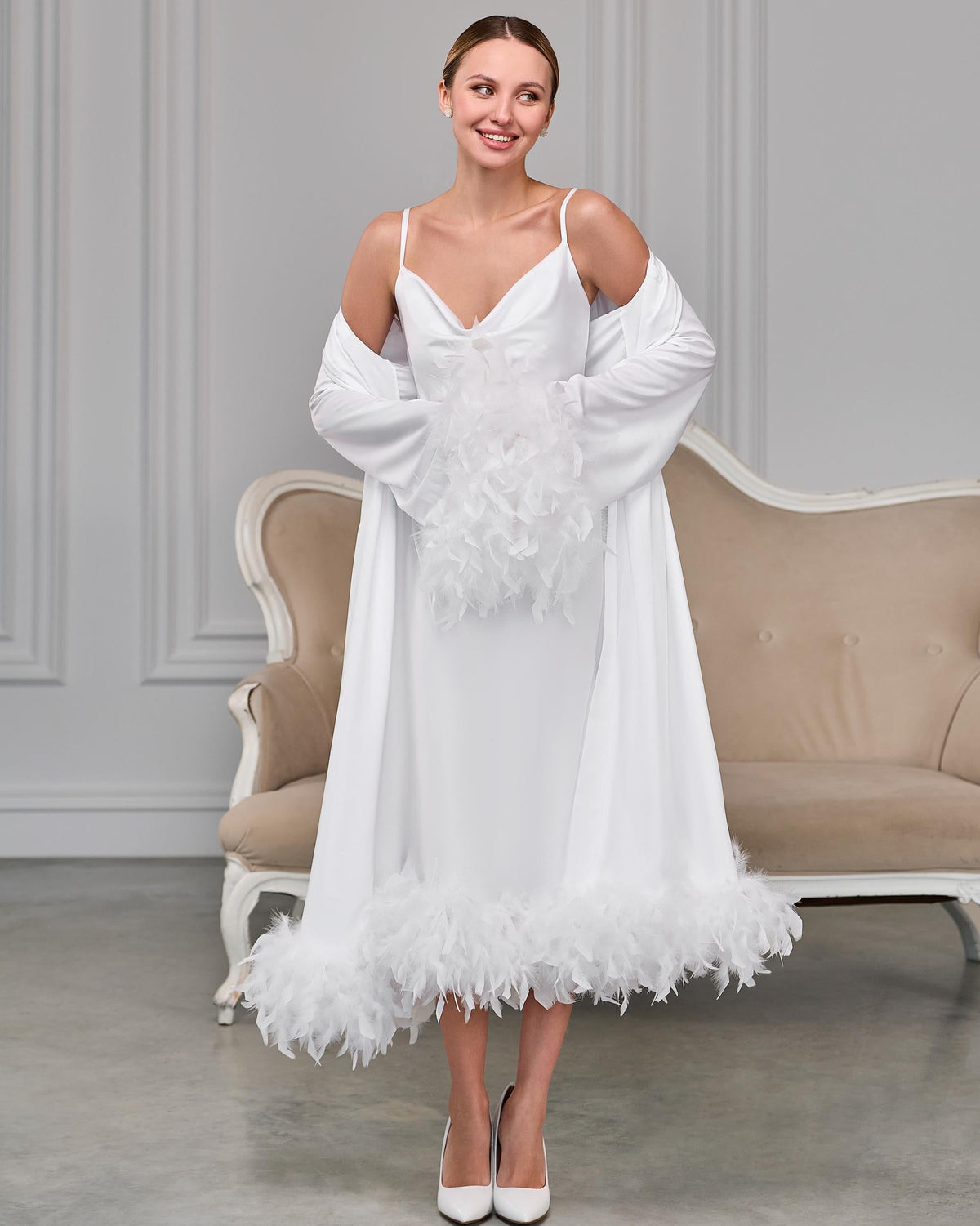 White satin wrap robe with soft feather details on the sleeves and hem