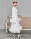 White bridal robe and slip dress with feather cuffs and hem, side view of model with vintage hairstyle