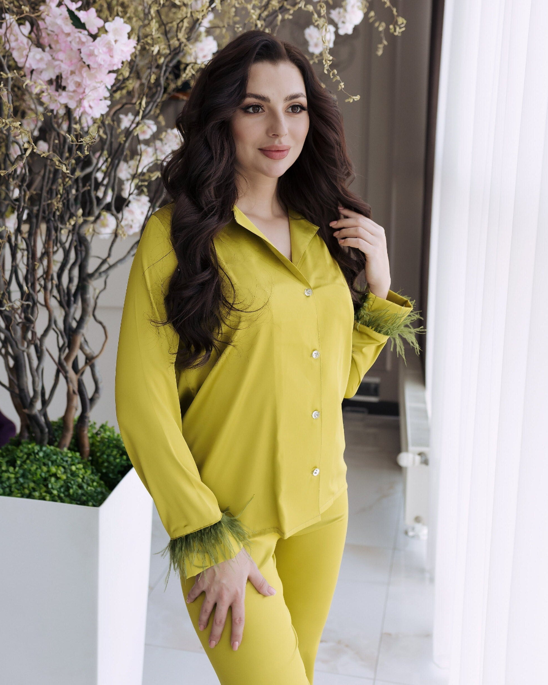 a woman in a yellow dress sitting on a purple chair