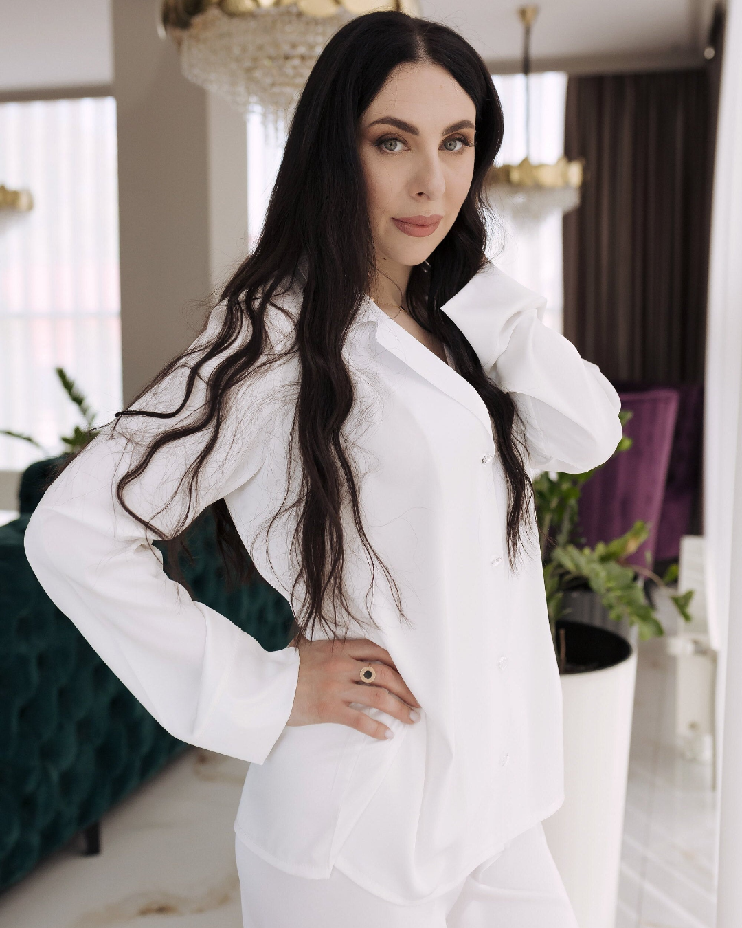 a woman in a white shirt and pants posing for a picture