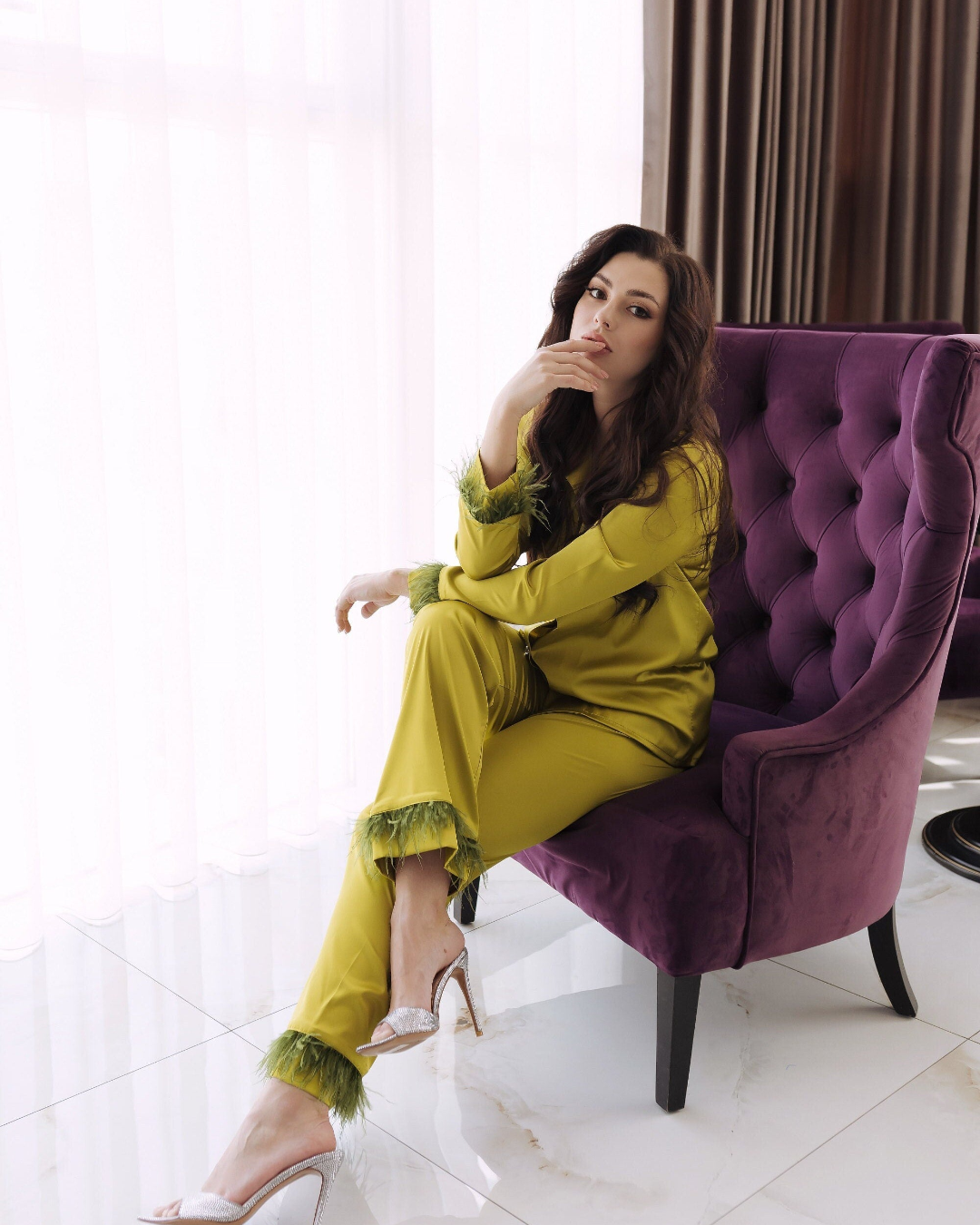 a woman sitting on a purple chair in a room