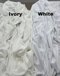 a bed with a white comforter and a white sheet