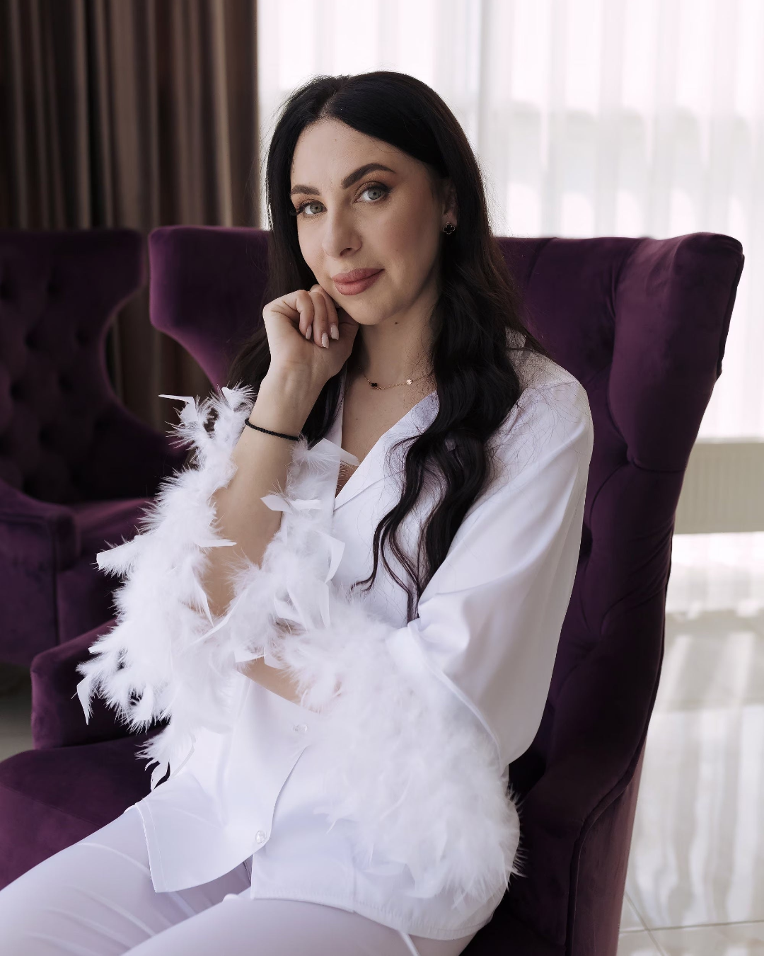 a woman standing in front of a green couch