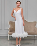 Minimalist white feather-trimmed slip dress, midi length with delicate cowl neckline, model standing in heels