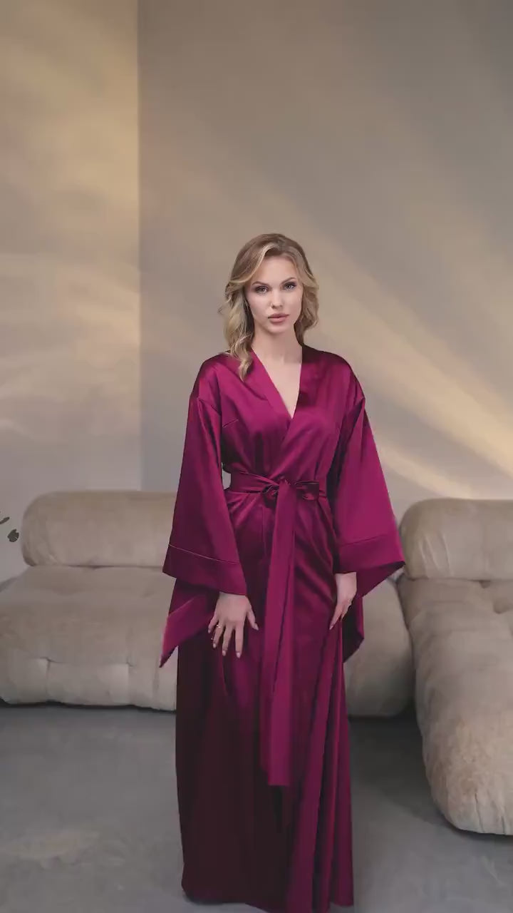 Video showing long satin kimono dressing gown on model with flowing wide sleeves