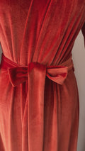 Video of burnt orange floor-length velvet wrap robe