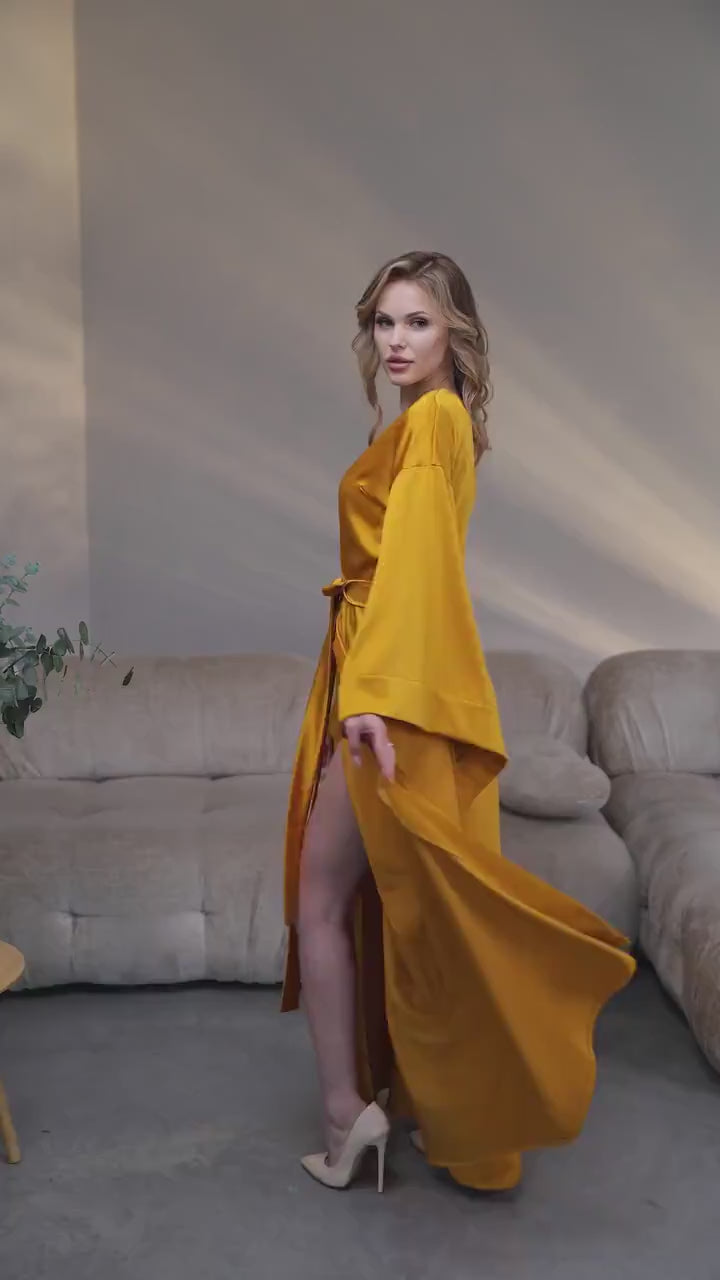 Video of a gold silk satin kimono robe with wide sleeves in motion
