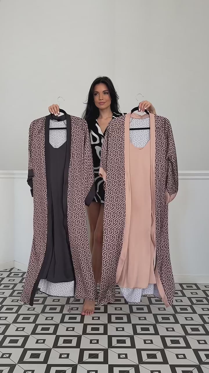 Two geometric patterned robes in blush and dark hues held by a model.

