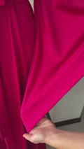Video close-up of glossy fuchsia silk satin fabric on the kimono robe sleeve