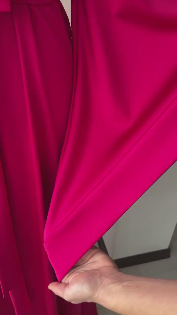 Video close-up of glossy fuchsia silk satin fabric on the kimono robe sleeve