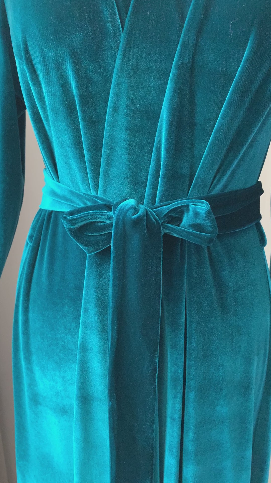 Video showcasing emerald green floor-length velvet wrap robe
