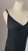 Video of a black satin nightgown with ostrich feather trim and an above-knee hem