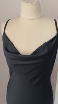 Video of black satin midi slip dress with draped neckline