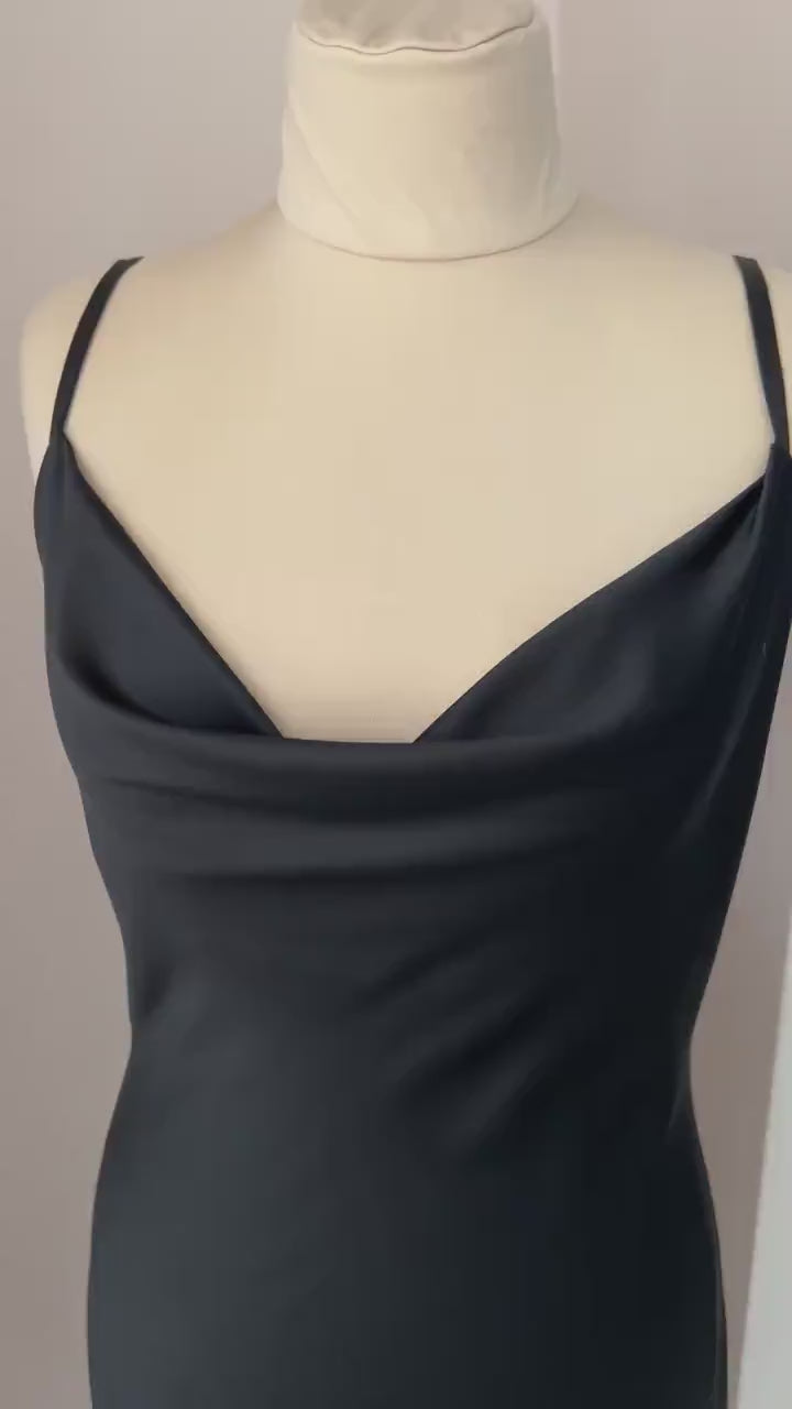 Video of black satin midi slip dress with draped neckline