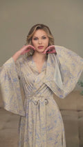 Video of a beige floral silk satin kimono robe with wide long sleeves