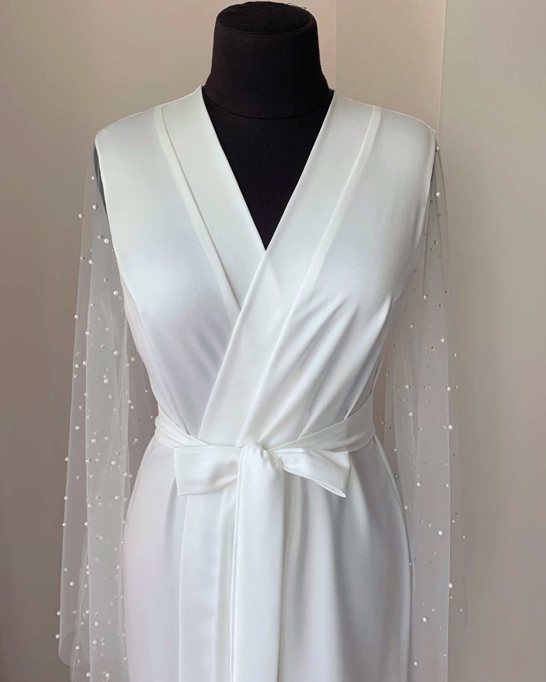 a white Pearl robe on a mannequin