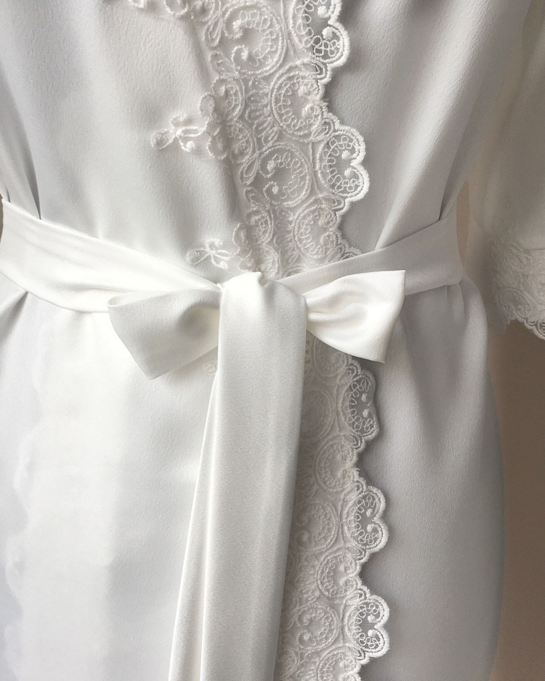 a white robe with a white ribbon tied around it