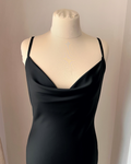 a black dress on a mannequin head stand