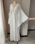 Chiffon robe with ostrich feathers on a mannequin in a room