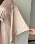 a woman's hand touching a dress on a mannequin