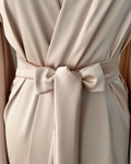 a close up of a dress with a tie on it