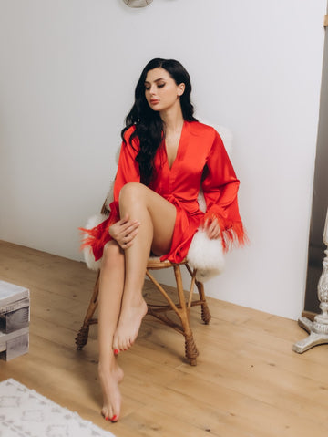 Red satin lounging robe with ostrich feather-trimmed sleeves