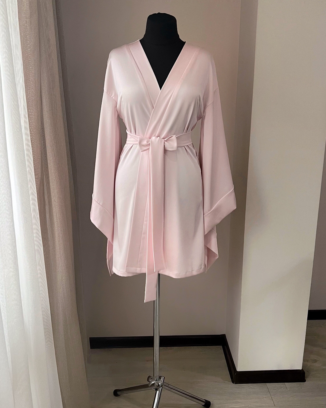 a woman's pink robe on a mannequin